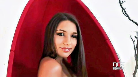 Seductive brunette with natural big tits and erect nipples posing topless in red egg chair