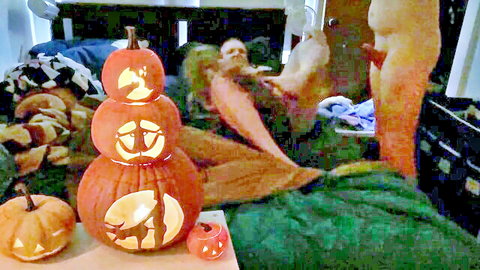 Sexy Halloween mermaid babe with big tits exposing bare ass on bed amid glowing jack-o-lantern pumpkins