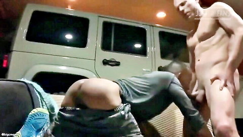 Naked muscular hunk with visible cock gropes exposed bubble butt of bent-over guy with pants down by van