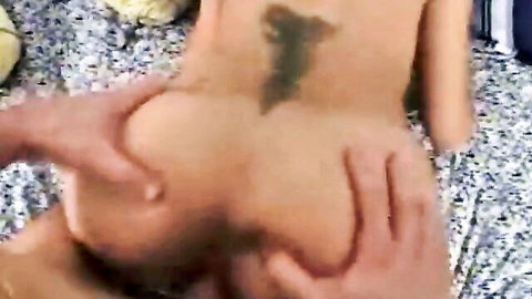 Man's hands grabbing and spreading nude woman's round ass cheeks from behind on bed