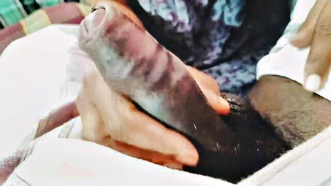 South Asian hand gripping thick veiny black cock with white towel closeup