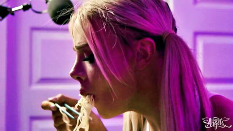 Busty trans woman with pink hair eating noodles seductively