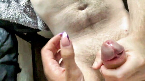 Woman with purple nails gripping and stroking big erect cock in hot handjob closeup
