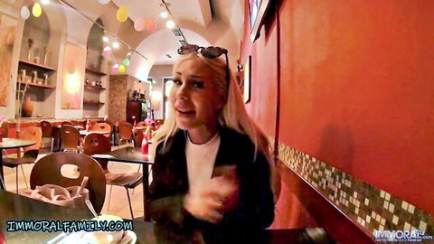 Blonde MILF with open mouth gasping surprised at restaurant table in taboo scene
