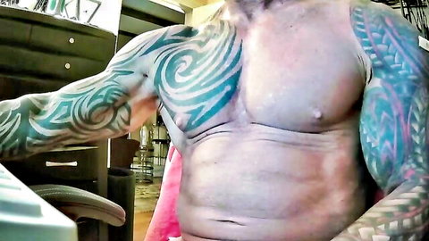Muscular tattooed guy shirtless flexing ripped abs and tribal tattoos in solo webcam