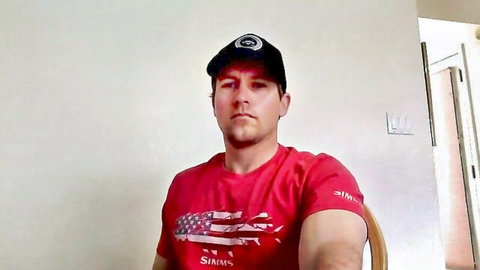 Muscular bearded daddy in red Simms shirt and cap teases on gay webcam