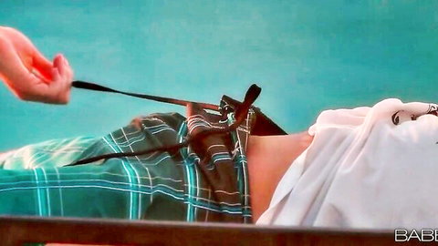 Skinny babe poolside with plaid skirt hiked up exposing shaved pussy held by black leash