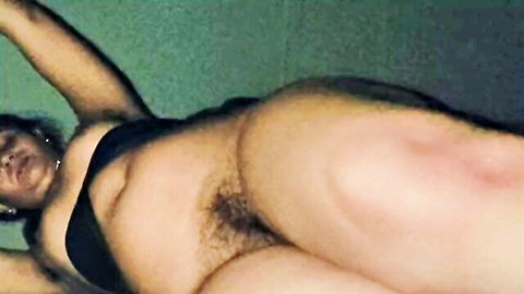 Nude curvy Indian woman lying sideways exposing big ass and hairy pussy