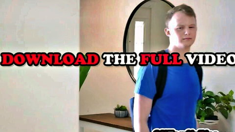 Blonde guy in blue shirt and backpack stands in room, from Jessica Ryan kinky swap family sex video