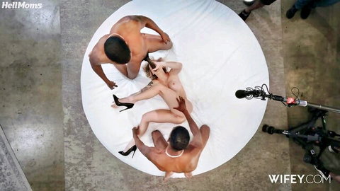 Tattooed blonde with fake tits fucked in pussy by BBC while sucking another in hot interracial threesome