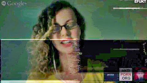 Curly haired glasses wearing babe smiles seductively in sexy porn thumbnail