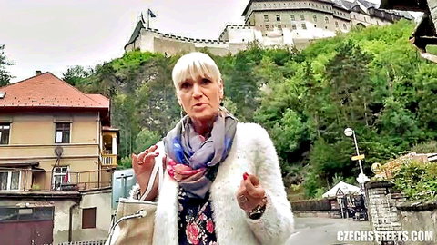 Daniela in Czech Streets 113, blonde mature woman outdoors in fluffy jacket and dress