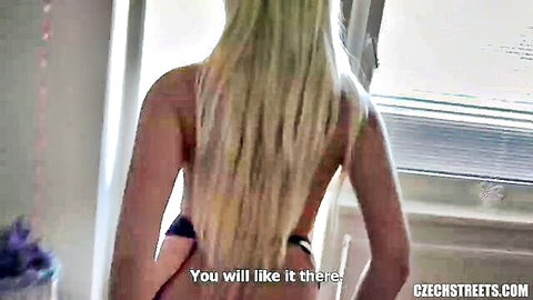 Blonde Czech woman topless in black thong posing by window
