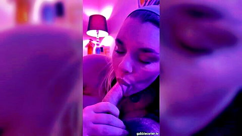 Gabbie Carter giving blowjob with hand grip in purple glow