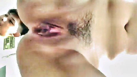 Amateur Southeast Asian spreads hairy wet pussy wide open revealing pink labia closeup