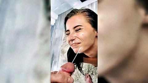 Wet blonde smiling with thick pink cockhead pressed to her lips in steamy shower blowjob