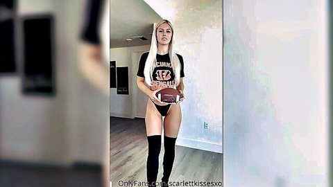 Blonde Bengals babe teasing bottomless holding football over shaved pussy in thigh highs