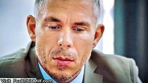 Mature man in suit gazes intently, hinting at office gaping scene