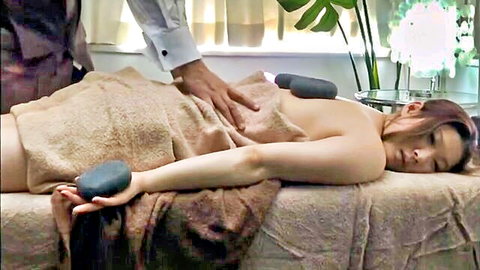 Asian married woman nude under towel getting hot stone oil massage