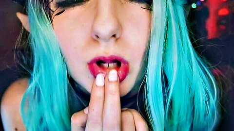 Teal-haired elf cosplay girl teases with tongue out and fingers
