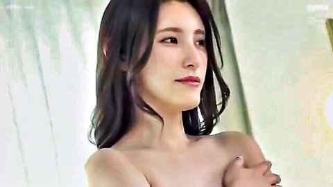 Stunning Asian babe topless covering her perky tits with arms seductively