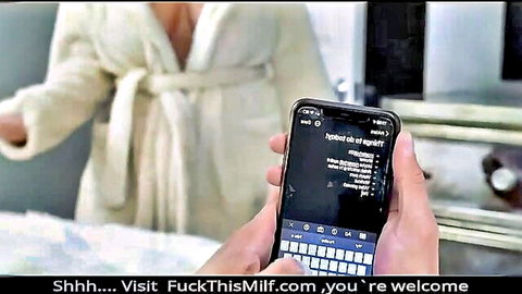 Busty MILF Natasha Nice in open white robe, holding phone tease