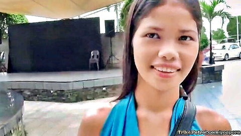 Smiling Filipina teen in blue top, stunning outdoor portrait