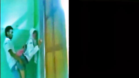 Indonesian hijab girl in lab coat lifted by guy against wall, amateur tease