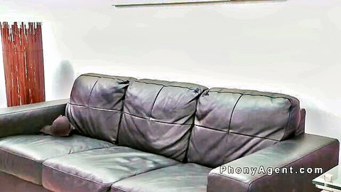 Busty Asian babe in fake agent casting setup on leather sofa