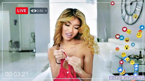 Petite blonde Asian teen exposes small perky tits teasing red bra on live cam