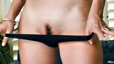 Shay Laren skinny solo pulls black panties aside exposing trimmed pussy