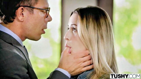Suited man in glasses chokes blonde beauty's throat intensely