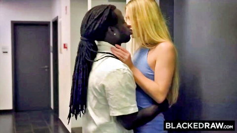 Blonde woman passionately kissing black man with dreadlocks