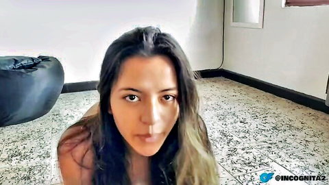 Latina teen kneeling topless on floor teasing with open mouth and perky tits