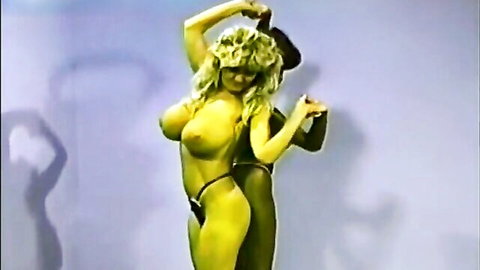 Busty blonde with huge bare tits poses topless in yellow micro bikini thong