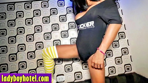 Curvy shemale with big breasts in black bodysuit and striped stockings posing