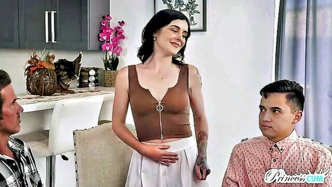 Brunette stepsister in crop top and skirt chats with two guys in kitchen, sensual vibe
