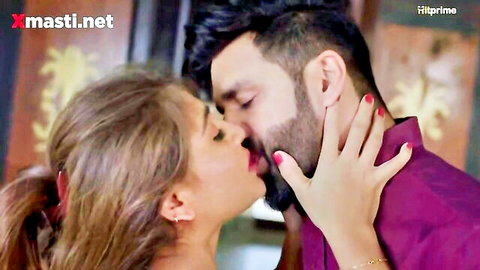 Passionate Indian couple sharing hot erotic kiss in intimate embrace