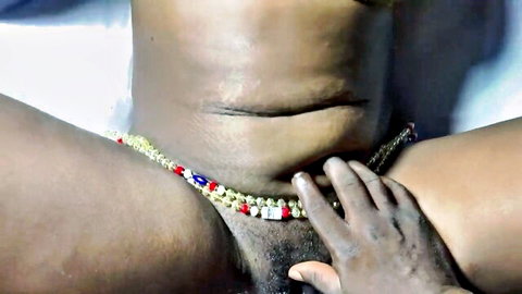 Hot ebony with waist beads intimately touched on dark skin closeup
