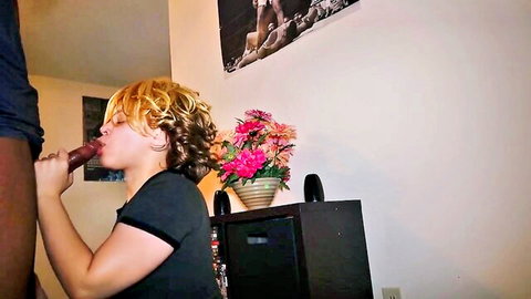 Curly blonde MILF sucking red dildo near black man in amateur oral scene