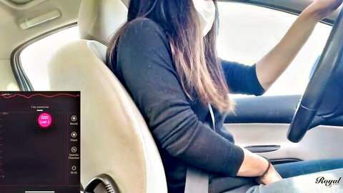Masked Asian woman drives car controlling remote pussy vibrator via phone app