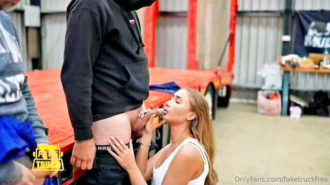 Skinny blonde kneels sucking hard cock outdoors in gangbang by truck