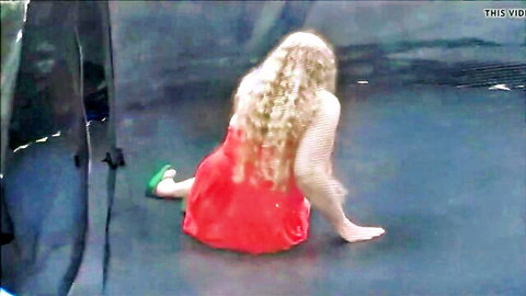 Blonde BBW wife in red dress sitting on trampoline