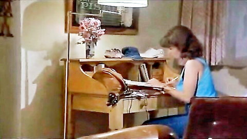 Valérie Rojan as Violette writing at desk in blue dress, 1987 vintage scene