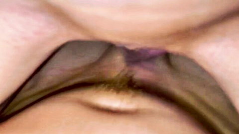 Closeup of woman's mouth stretched wide around thick glossy black dildo in deepthroat blowjob