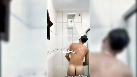 Naked Asian man showering from behind exposing his bare muscular ass cheeks
