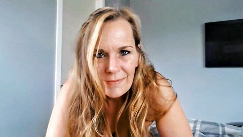 Blonde MILF with memory loss smiling topless in amateur video