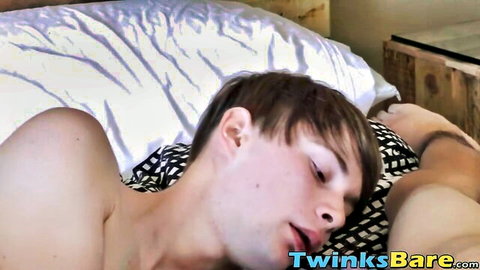 Skinny young gay twinks lying shirtless embracing on bed