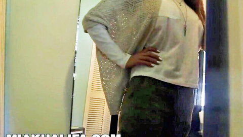Sexy Arab babe posing in mirror with sparkly shawl and pants
