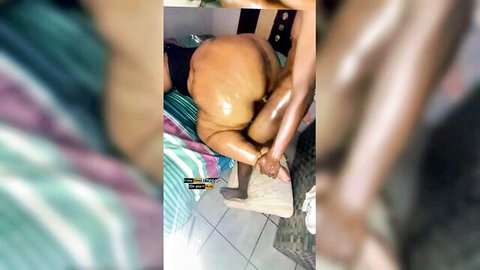 Ebony babe's massive shiny ass spread wide as thick black cock fucks her pussy doggy style